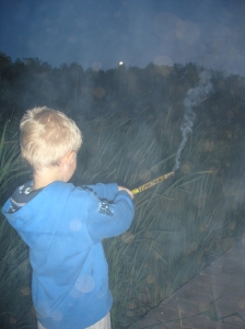 Jason letting Kallen shoot off roman candles - don't try this at home.  NOT good parenting!